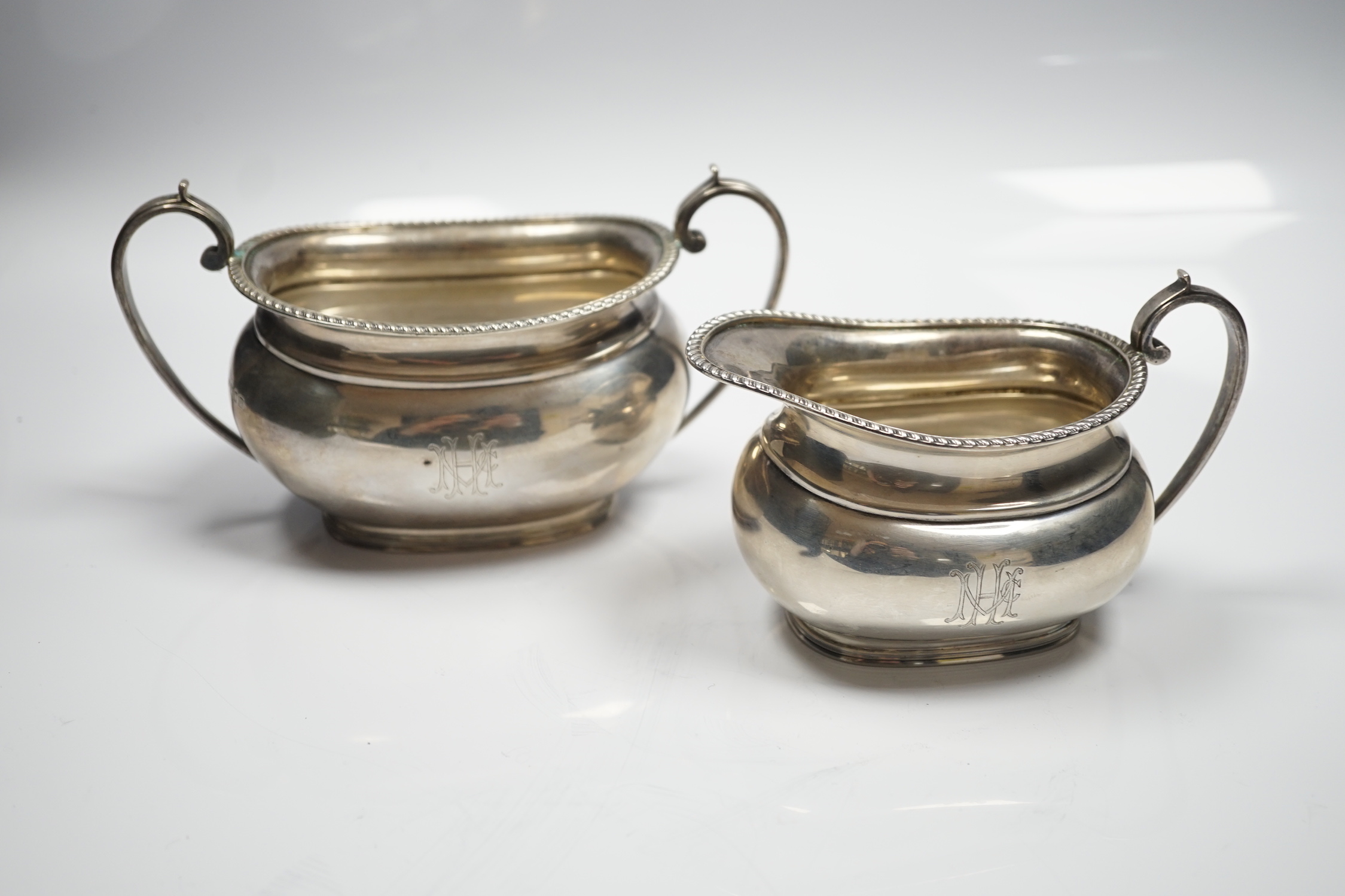 A George V silver oval cream jug and sugar bowl, Sebastian Garrard, London, 1927, 14.8oz.